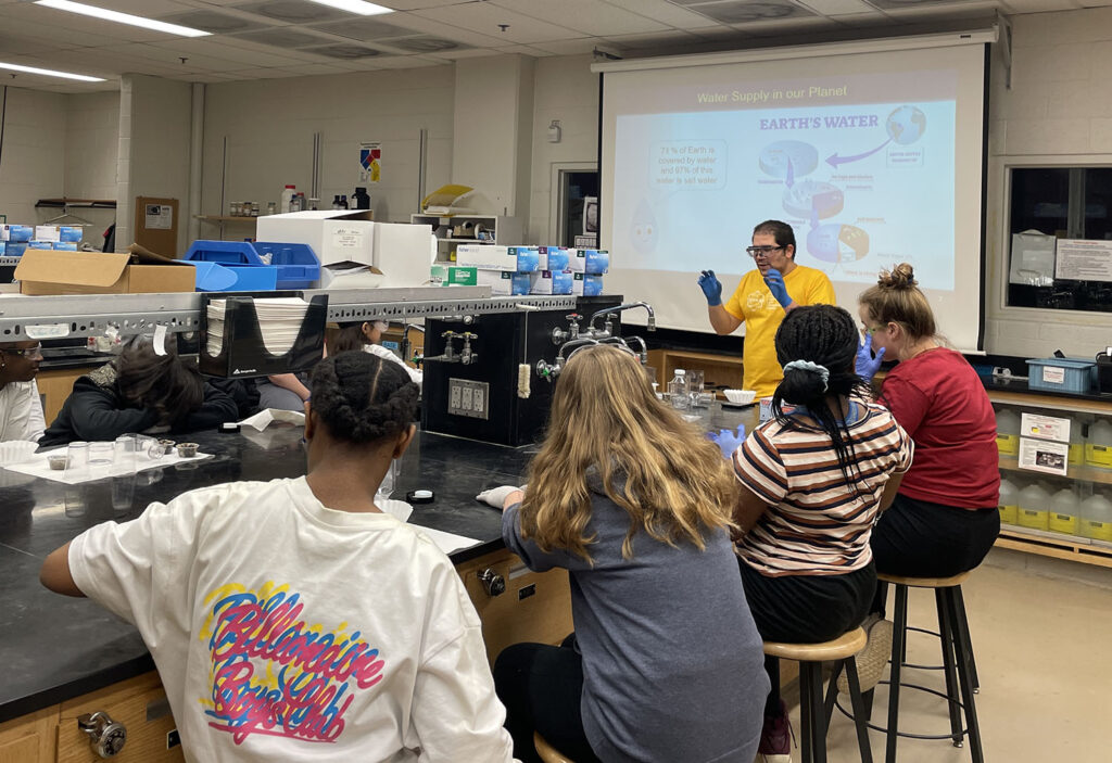 Graduate student José Carlos Díaz teaching students about water availability and quality.