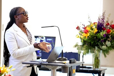 Lola Eniola-Adefeso speaks at podium at the installation ceremony for her Vennema Professorship. 